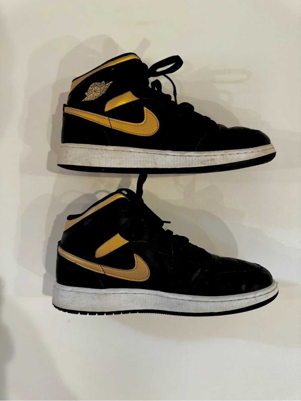 Nike Air Jordan 1 Mid Black with Gold Swoosh
